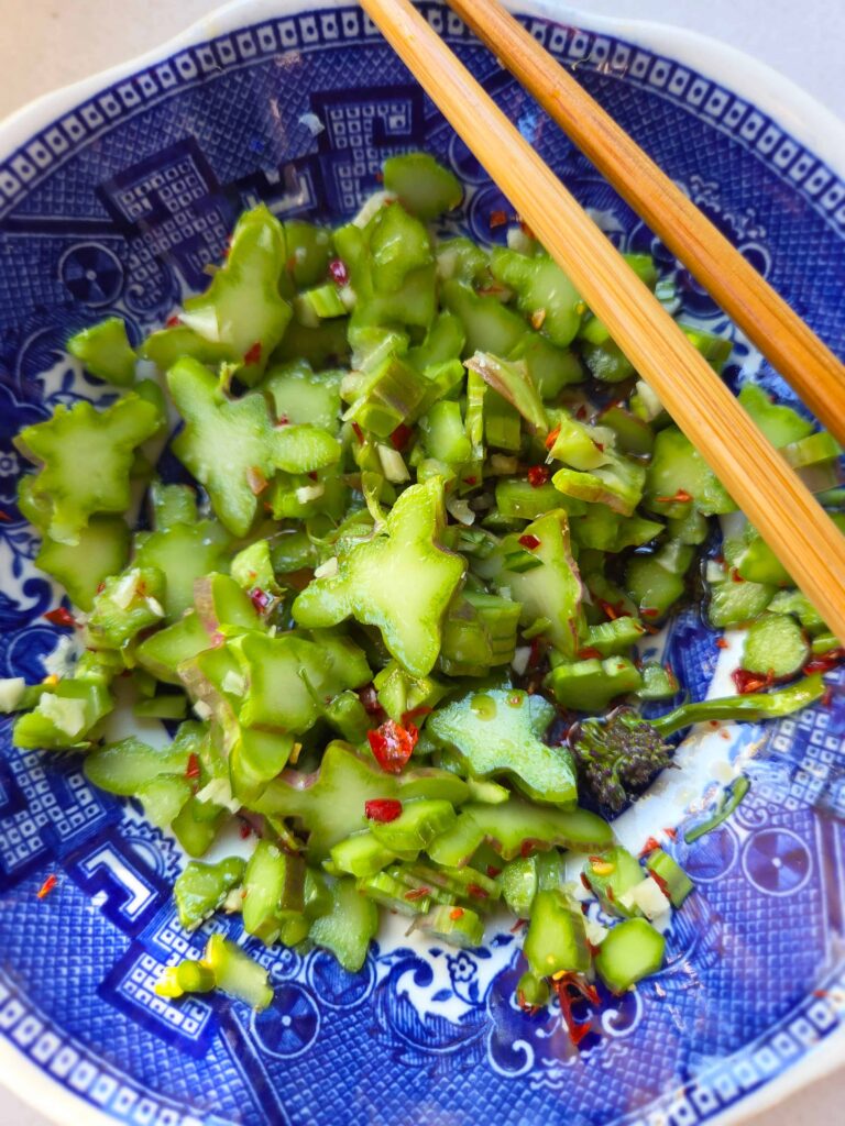 sliced up broccoli stems marinaded with rice vinegar, salt, and chili and garlic.