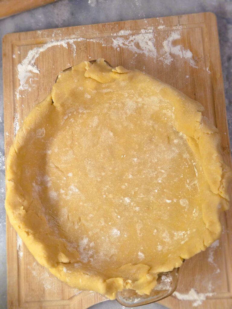 Dough placed gently on the pie pan